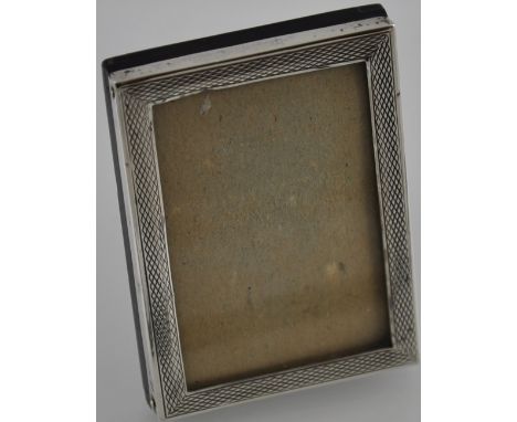 A silver engine turned easel back photograph frame with original glass, hallmarked Birmingham 1926 by Sanders & Mackenzie