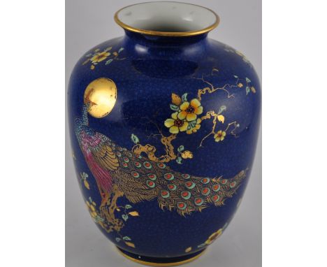 A George Jones & Sons blue glazed vase with hand-painted gilt and enamel peacock motif decoration. H. 27cm