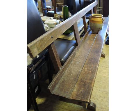 An early 20th Century oak church pew, formerly from the Hounslow Salvation Army chapel. L. 260cm