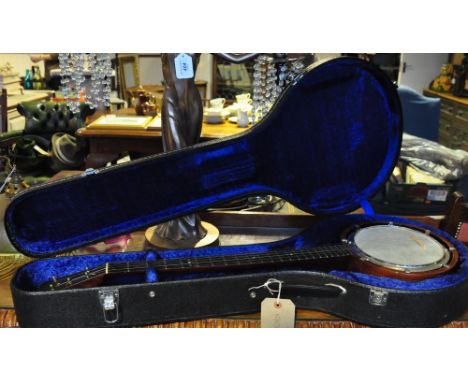 A cased vintage 5 string banjo