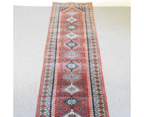 A North-West Persian runner, with a row of central medallions, 395 x 85cm