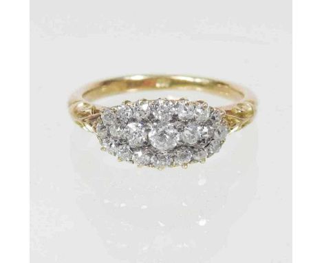 A diamond cluster ring, of elliptical shape, set with twenty diamonds, with textured shoulders, marked indistinctly, 2.9g, si