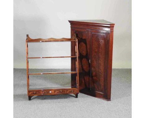 An early 20th century mahogany hanging corner cabinet, 76cm wide, together with a three tier hanging shelf, 68cm wide (2)