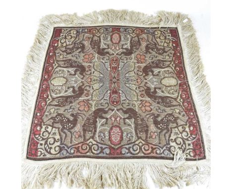An Arabian tapestry, decorated with animals and scrolls, 74 x 74cm