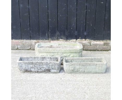 A large rectangular carved stone garden planter, 71cm wide, together with a pair of garden troughs (3)