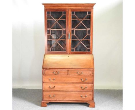 An Edwardian mahogany bureau bookcase, with a fitted interior, on bracket feet. Note: a non-transferable ivory exemption cert
