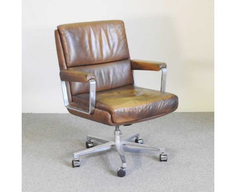 A 1970's brown upholstered swivel desk chair, in the style of Eugen SchmidtOverall condition is complete and usable. Dirty. T