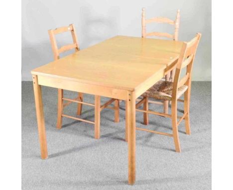 A 1960's extending dining table, 180 x 81cm, together with three rush seated beech dining chairs, probably Habitat and a ligh