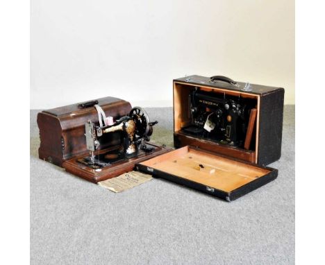 An early 20th century sewing machine, cased, together with another (2)