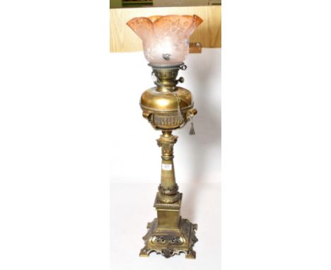 An impressive Victorian brass oil lamp with etched shade with three spare chimneys, 67cm excluding shade and funnel