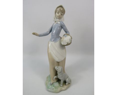 Nao figurine of a girl with a basket and dog at her feet, 10.5" tall.