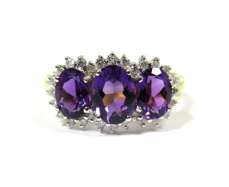 9ct Yellow Gold Ring set with Triple Amethysts with Diamond Surrounds.  Finger size 'S'   2.4g