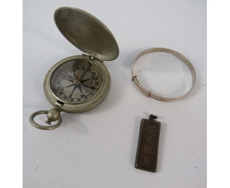 White metal US compass, a sterling silver ingot and a sterling silver childs bracelet.