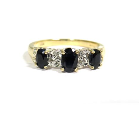 9ct Yellow Gold Ring set with a Trio of Sapphires (6 x 4mm &amp; 4 x 3mm) Surrounded by Small Diamonds. Finger size 'P'  2.8g