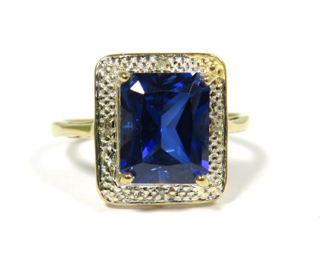9ct Yellow Gold Ring set with a Blue Central Sapphire (10 x 8mm) with Diamond Chip Surround.  Finger size 'R'  3.9g