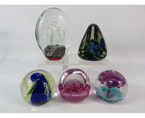 Five art glass paperweights including some by Caithness and Mdina.