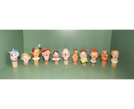 Eleven ceramic vintage bottle stops including Goebel.