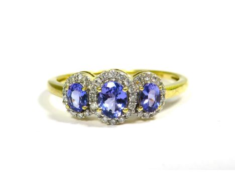 9ct Yellow Gold Ring set with a trio of Tanzanite Coloured Gemstones with CZ Surround. Finger size 'P'   2.0g
