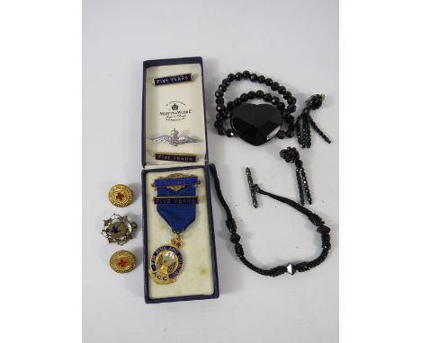 Mixed lot to include enamel badges, distinguished service medal, whitby jet ? Albert chain etc.