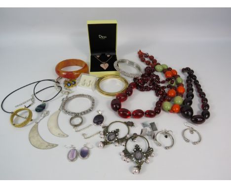 Mixed costume jewellery including a bakelite bangle, cherry bead necklaces and some sterling silver items.