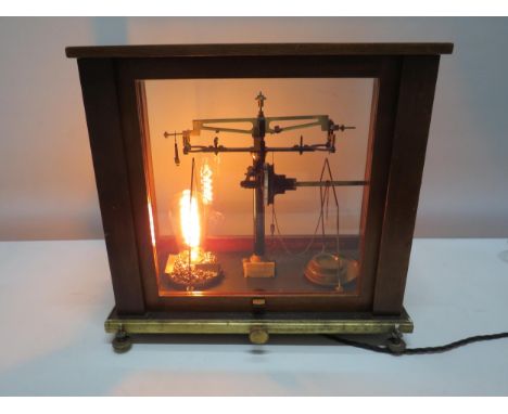 Vintage Baird and Tatlock scientific scales in glass and wooden case converted to a lamp. 15.5" wide, 8.5" deep and 15" tall 