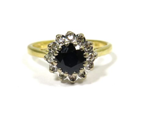 18ct Yellow Gold Ring set with a Central Circular Sapphire with Diamond Surround. Finger size 'M'   4.3g