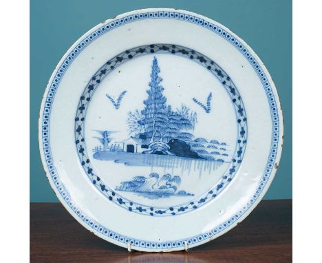An 18th century English Delftware large plate or charger, possibly Lambeth, decorated with trees and buildings on an island35