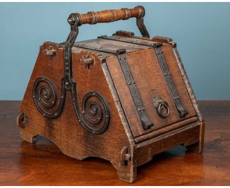 A 19th century Benham &amp; Froud aesthetic oak and wrought iron coal box with turned handle and of pegged construction to th