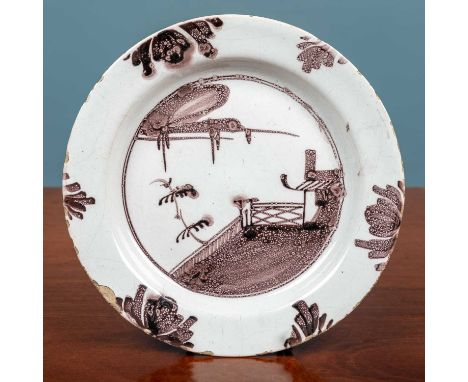 An 18th century English delftware plate, decorated with a chinoiserie scene in manganese purple18cm diameterQty: 1With minor 