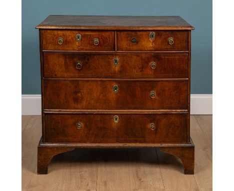 A Queen Anne walnut chest of two short and three long drawers with decorative strung inlay and ring handles, decorative inlay