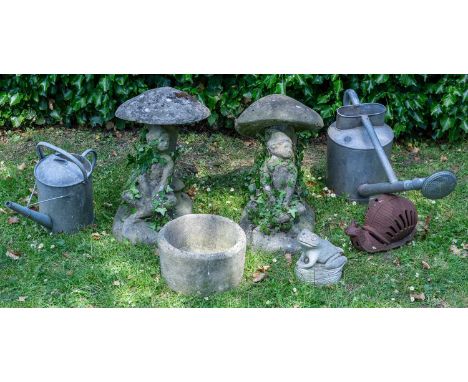 A group of garden items to include: two characters under toadstools; two watering cans; a frog and snail; and a planterthe to