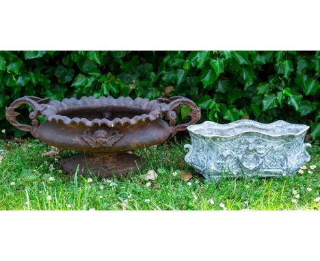 A French cast iron oval garden planter with scrolling handles; together with a small painted cast iron campana urn; and a sma