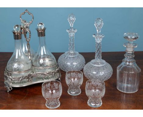 A pair of cut glass decanters and stoppers, etched with a frieze of fruiting vine; together with a modern silver plated tripl