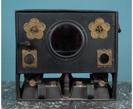 A small black painted iron stove with brass fittings and paraffin burners beneath, labelled to the front 'Rippingille's Paten