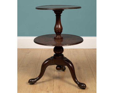 A mahogany two-tier dumb waiter of small size with turned baluster support between the two circular tiers, all on a tripod ba