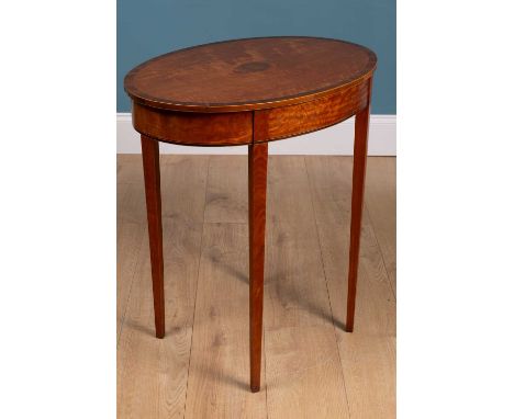 An antique satinwood oval lamp table, with walnut cross banded ornament and standing on square tapering legs69cm wide x 48cm 