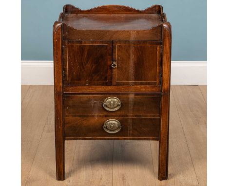 A 19th Century mahogany pot cupboard, the galleried top with pierced handles, twin doors to the front and two faux drawers pu