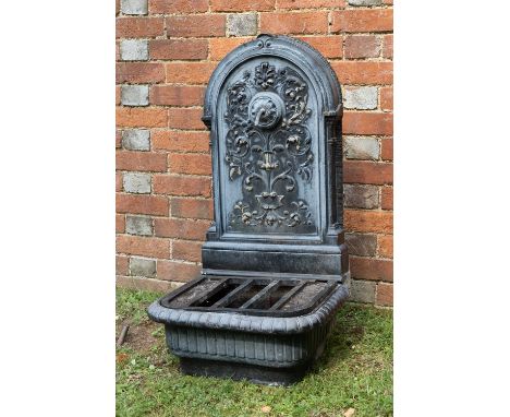 A cast aluminium water fountain with a spout surrounded by scrolling acanthus leaves over a basin topped with a grill49cm wid