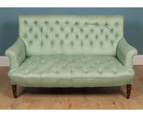 A 19th century pale green button upholstered two seater deep sofa with turned front legs and ceramic castors152cm wide x 92cm