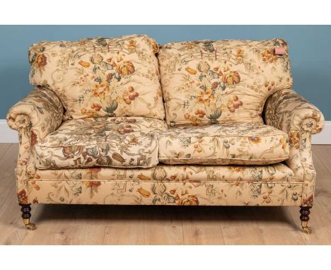 A George Smith two seater sofa, with turned tapering front legs terminating in brass castors and labelled beneath160cm wide x