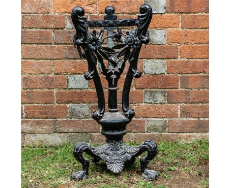 An antique painted cast and wrought iron stand, with foliate swags and on a tripod base cast with paw feet34cm wide x 73cm hi
