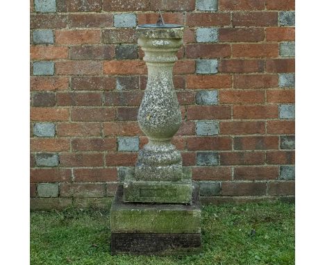 A sundial constructed from a cast reconstituted stone baluster removed in the restoration of Magdalen Bridge, Oxford, on a st