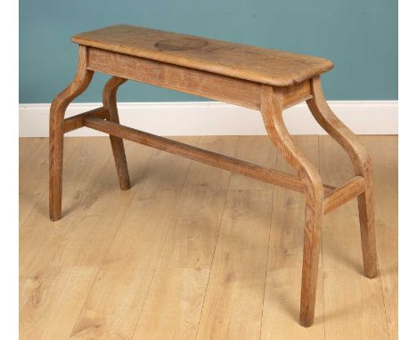 An old pitch pine pipe organ bench with splaying legs united by a stretcher125cm wide x 29cm deep x 74cm highQty: 1Minor mark