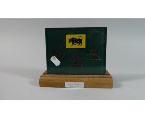 A Military Desktop Plaque Decorated with Cap Badges of Fourth Battalion King's Shropshire Light Infantry, Hereford Regiment a