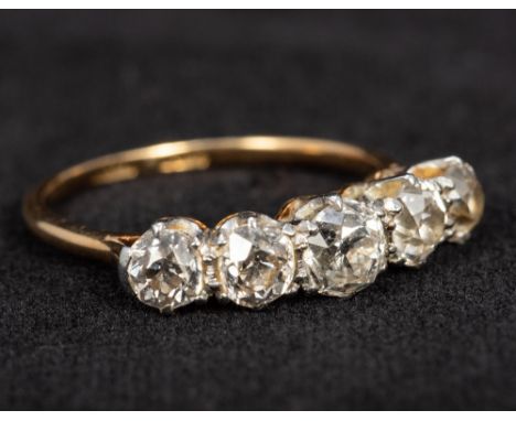 An 18 ct gold and platinum five stone diamond ringThe central stone approximately 0.4 carat.  CONDITION REPORTS: Generally in