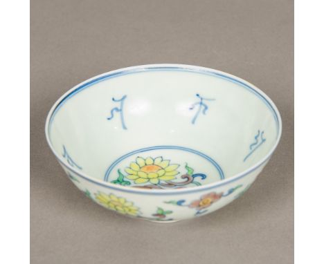 A Chinese Wucai porcelain bowlDecorated with floral sprays and archaic characters, blue painted six character Chenghua seal m