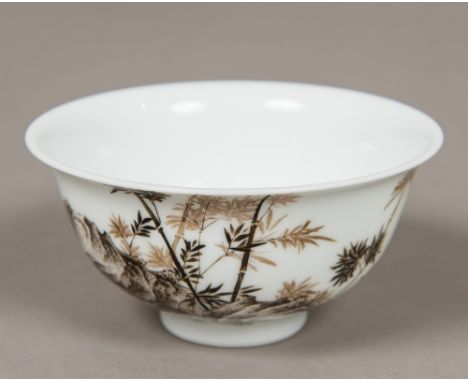 A Chinese porcelain bowlDecorated with a rock issuing bamboo opposing calligraphic script and red seal marks, blue painted fo