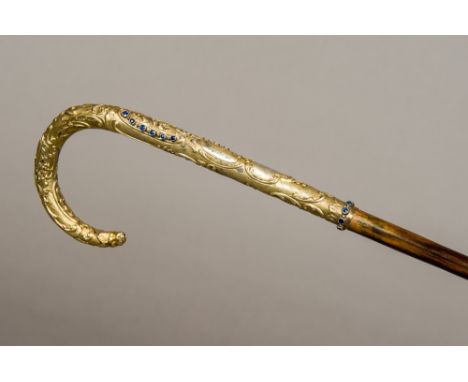 A 19th century Austro-Hungarian sapphire set silver gilt handled walking caneThe florally scroll cast handle set with three r