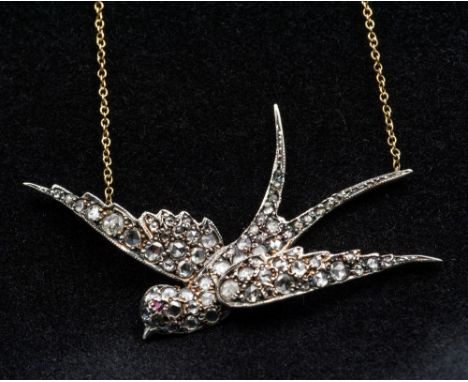 An unmarked diamond and ruby set pendant on an 18 ct gold chainFormed as a swallow in flight.  5 cm wide.  CONDITION REPORTS: