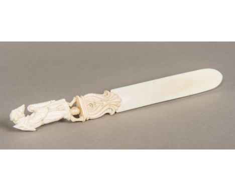 A 19th century Dieppe ivory page turnerThe finial carved as a fox in monk's costume.  28 cm long.  CONDITION REPORTS: General